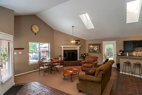 a living room with a couch and a table and a fireplace
